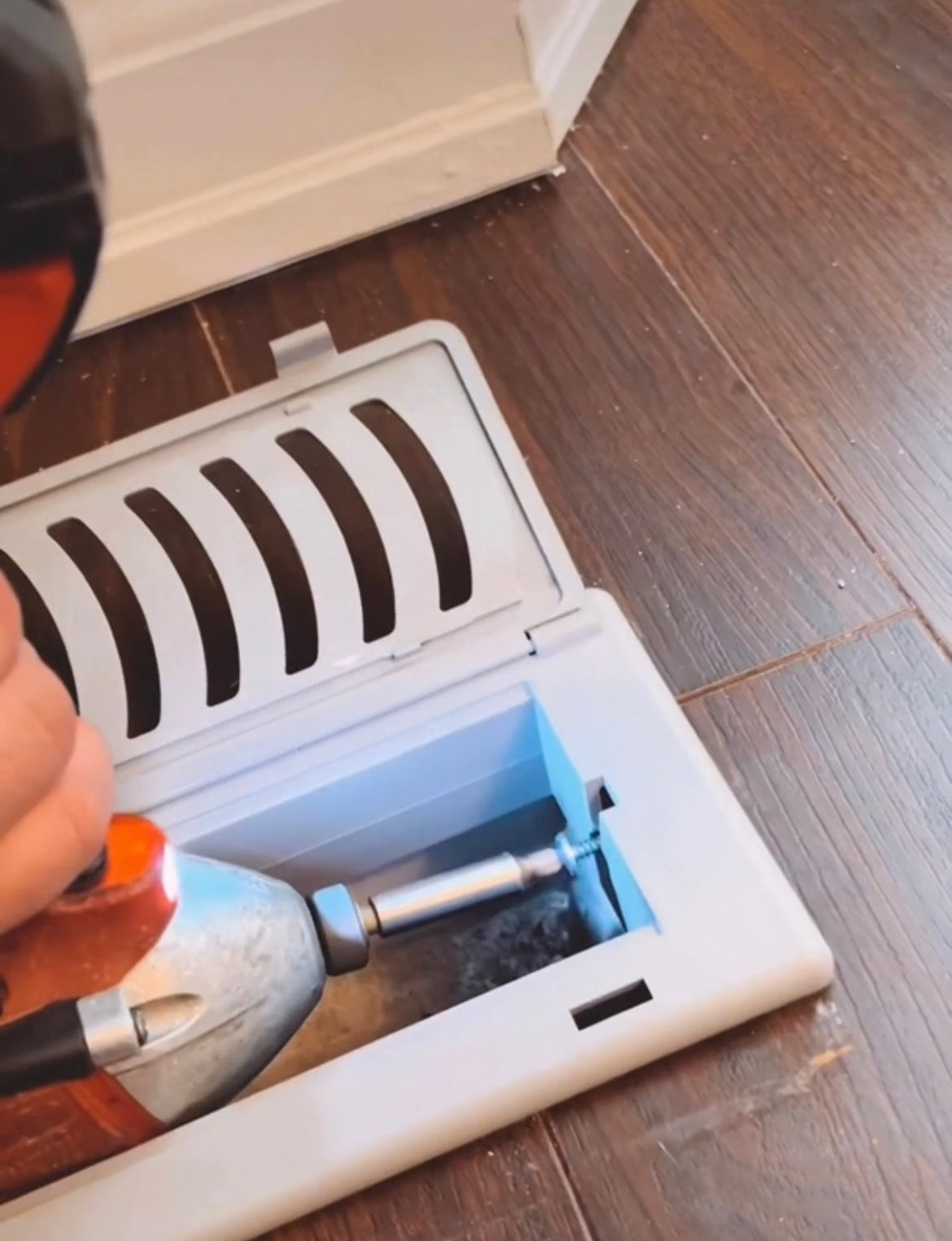 man with drill installing a Childproof Babyproof air vent cover