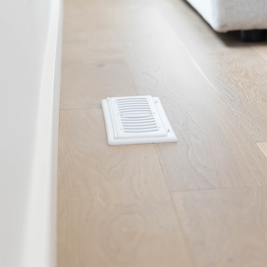 white childproof vent cover floor register for air vents in a wood floor