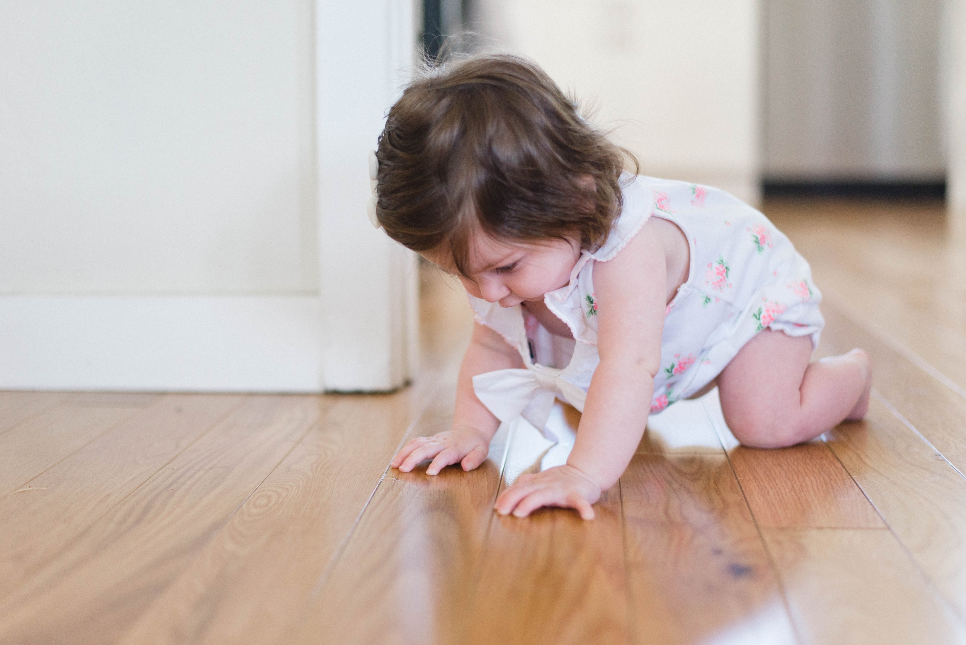 Baby crawling on the floor advertising childproof vent covers